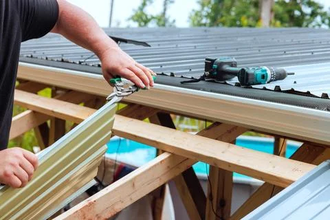 Roof installation process at construction site Stock Photos
