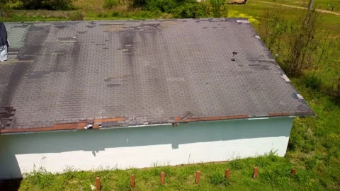 Roof missing shingles due to age, weather and storm damage Stock Footage 239461886