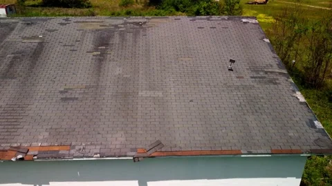 Roof missing shingles due to age, weather and storm damage Stock Footage 239461928