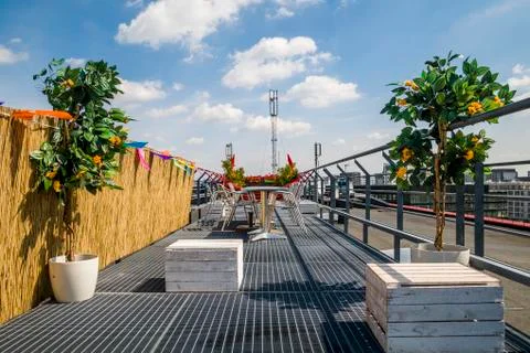 Roof terrace chairs table boxes and plants. Stock Photos