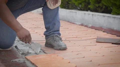 Roofer aligning flat terracotta tiles on mortar bed Stock-Footage 345695251