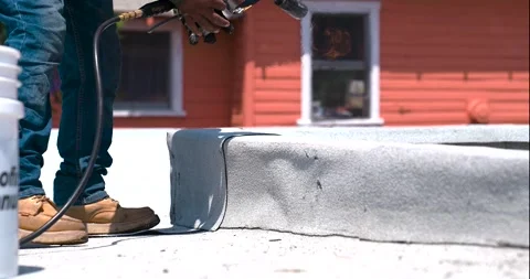 Roofer applying granulated APP Torch Down and Using a Roller Stock Footage 277974073