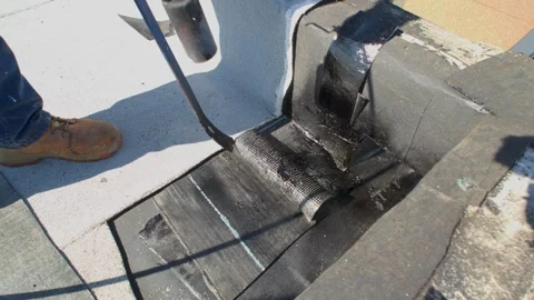 Roofer applying granulated APP Torch Down  Stock Footage 328283408