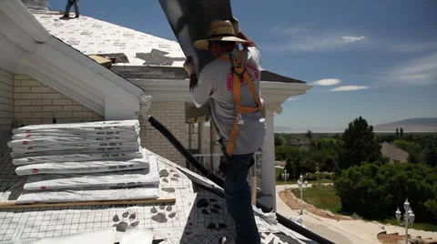 Roofer carrying sheet of metal Stock Footage 26339385