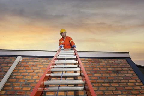 Roofer Construction worker install new roof,Roofing tools,Electric drill used Stock Photos