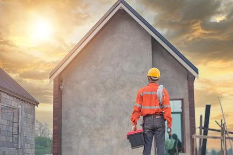 Roofer Construction worker install new roof,Roofing tools,Electric drill used Stock Photos