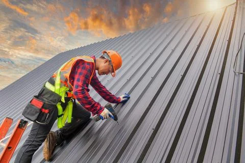 Roofer Construction worker install new roof,Roofing tools Stock Photos