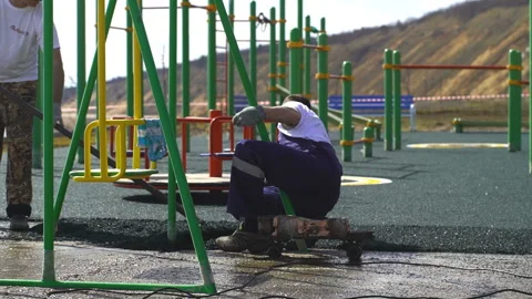 Roofer cover the concrete base, polymer modified bitumen waterproofing primer Stock Footage 91720570