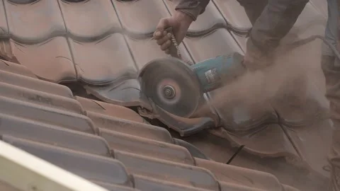 Roofer cutting roof tile with an angle grinder Stock Footage 201935800