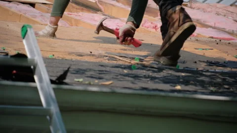 Roofer removes old nail of damaged roof covering before installing a n Stock Footage 306337576