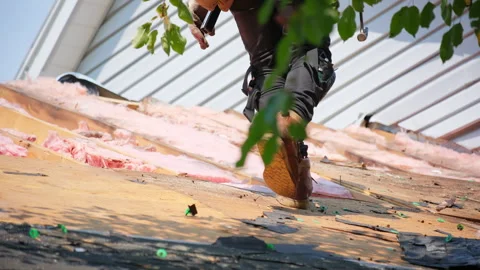 Roofer removes old wood decking of the damaged roof before installing Stock Footage 306432726