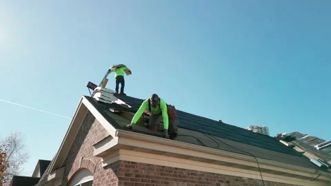 Roofer repair or replace shingle that has been damaged and needing replacement Stock Footage 222013894