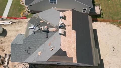 Roofer repair or replace shingle that has been damaged and needing replacement Stock Footage 252397516