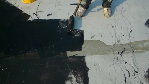 Roofer team lay black roofing material on white flat roof. Stock Footage 144941554