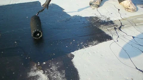 Roofer team lay black roofing material on white flat roof. Stock Footage 144941573