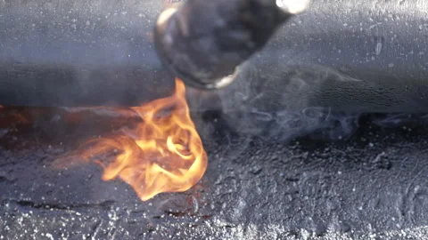 A roofer is welding the roofing felt with fire Stock Footage 172486621