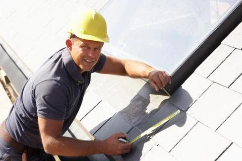 Roofer Working On Exterior Of New Home Stock Photos