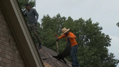 Roofers begin removing old tiles from damaged roof, 3K. Stock Footage 116098017