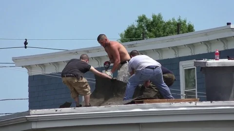 Roofers remove old torn tiles from two family house Stock Footage