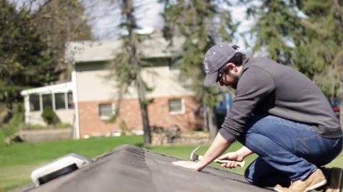 Roofing Expert or contractor checking the shingles on ranch home Video stock 74309001