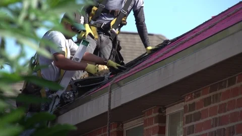 Roofing Guy Uses Nail Gun to Hang Shingles 動画素材 85358757