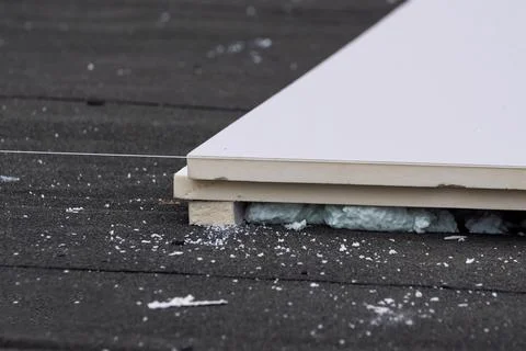 Roofing insulation, installation of insulation sheets on foam Stock Photos