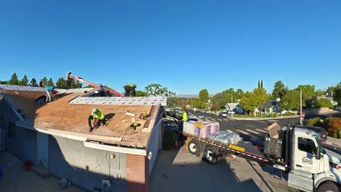 Roofing. Removal of old roof, replacement of new shingles, crew working, repair Stock Footage 346917003