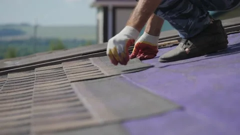 Roofing work. Laying a soft roof on the roof of a private house. Stock Footage