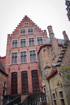 Roofs And Windows Of Old Authentic Brick Houses And Church In Bruges, Belgium Stock Photos