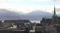 Roofs of old town in Lausanne on bank of Lake Geneva, majestic Alps on horizon HD Footage