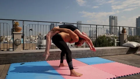 Rooftop AcroYoga session Stock Footage 118974424