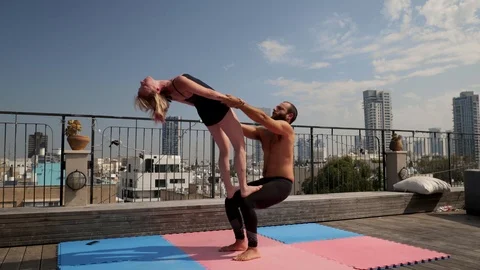 Rooftop AcroYoga session Stock Footage 118974915