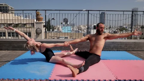 Rooftop AcroYoga session Stock Footage 118975248