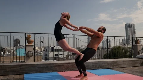 Rooftop AcroYoga session Stock Footage 118976235