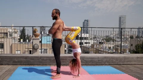 Rooftop AcroYoga session Stock Footage 118978833