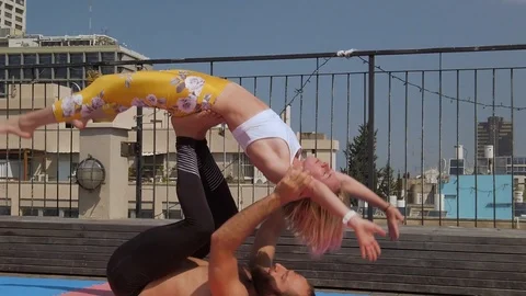 Rooftop AcroYoga session Stock Footage 118980220