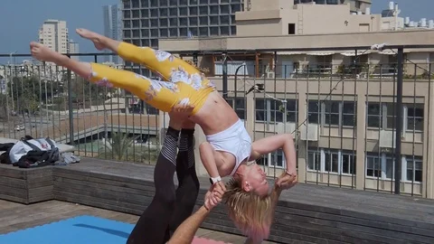 Rooftop AcroYoga session Stock Footage 118982332