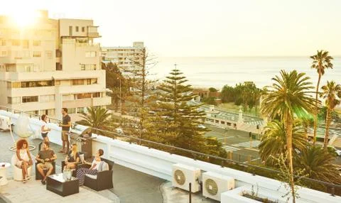 Rooftop barbaque at sunset with group of attractive young adults Fotos Stock