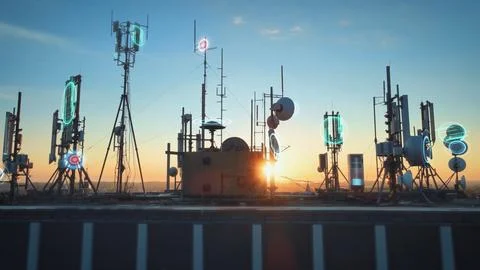 Rooftop base station at sunset covered with telecom tower antenna Stock Photos