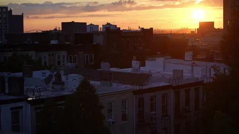 Rooftop City Sunset: Birds, Clouds, Traffic in Skyline, Pan-Right Shot Stock Footage 260120842