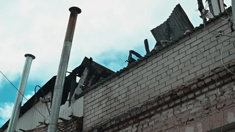 Rooftop of a damaged building where debris and structures are exposed against Stock Footage 339095981