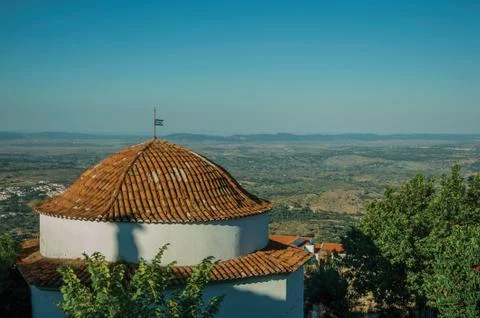 Rooftop in dome shape over rounded house next to trees Stock Photos
