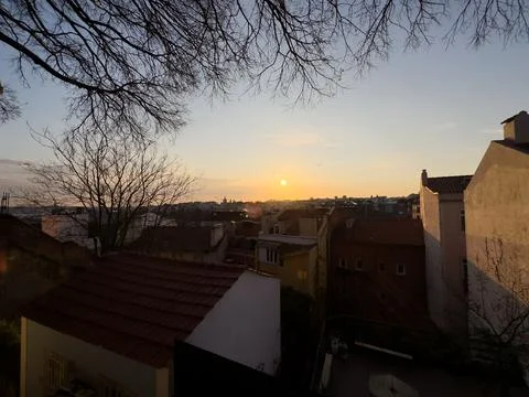 Rooftop empty brick floor with panoramic city skyline during sunset. Stock Photos