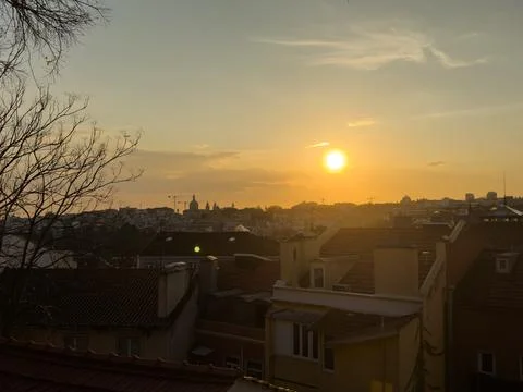 Rooftop empty brick floor with panoramic city skyline during sunset. Stock Photos
