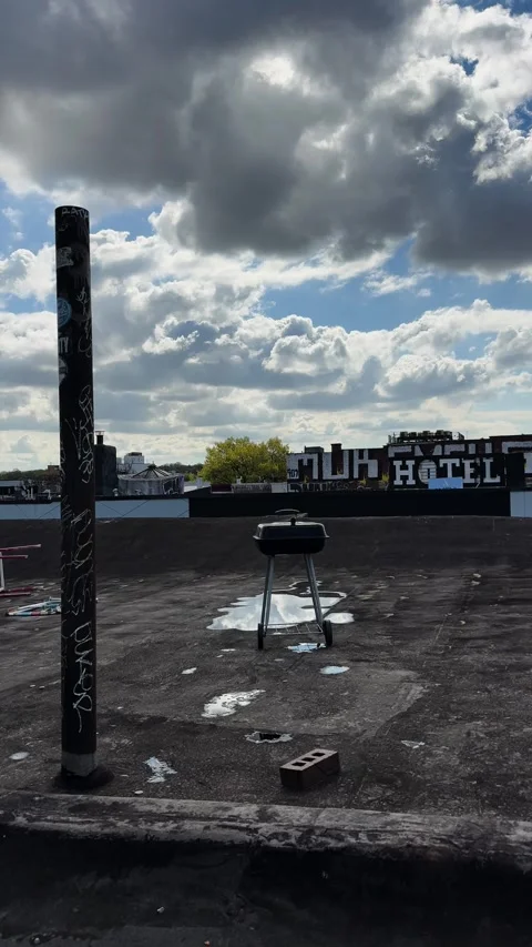 Rooftop Grill and Puddles Below Dramatic Clouds in Urban Bushwick Setting Stock Footage 334206055