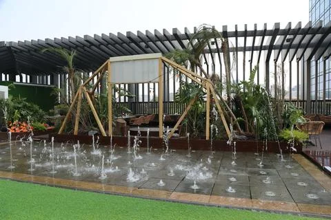 The rooftop of the hotel features an outdoor water fountain and wooden stru.. Stock Photos