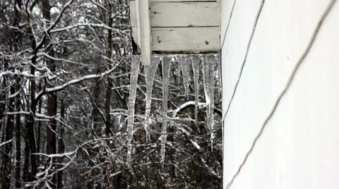 Rooftop icicles in the middle of the forest. Stock Photos