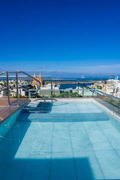 Rooftop infinity pool views over Mellieha with sanctuary and bay Stock Photos
