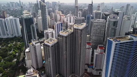 Rooftop Level Flyover Through Makati Office and Condo Towers 動画素材 330851434