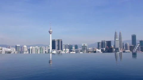 Rooftop panoramic view on Kuala Lumpur over infinite swimming pool. The city 動画素材 232959189
